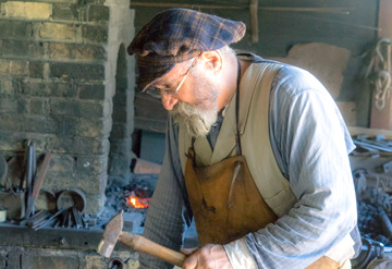Picture of a blacksmith working with tools